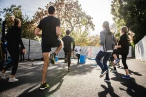 Person jogging outdoors, illustrating the role of exercise in speeding up the detox process